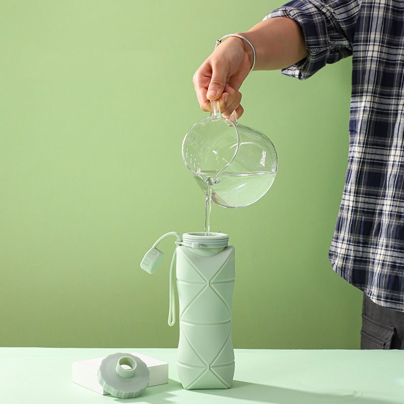 collapsible silicone bottle being filled with water for daily hydration